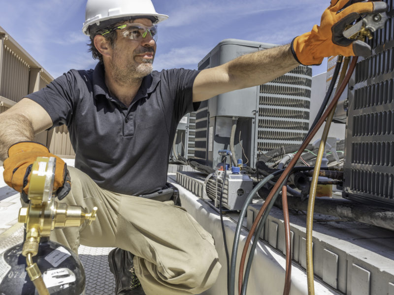 HVAC Technician Repairing a AC Unit